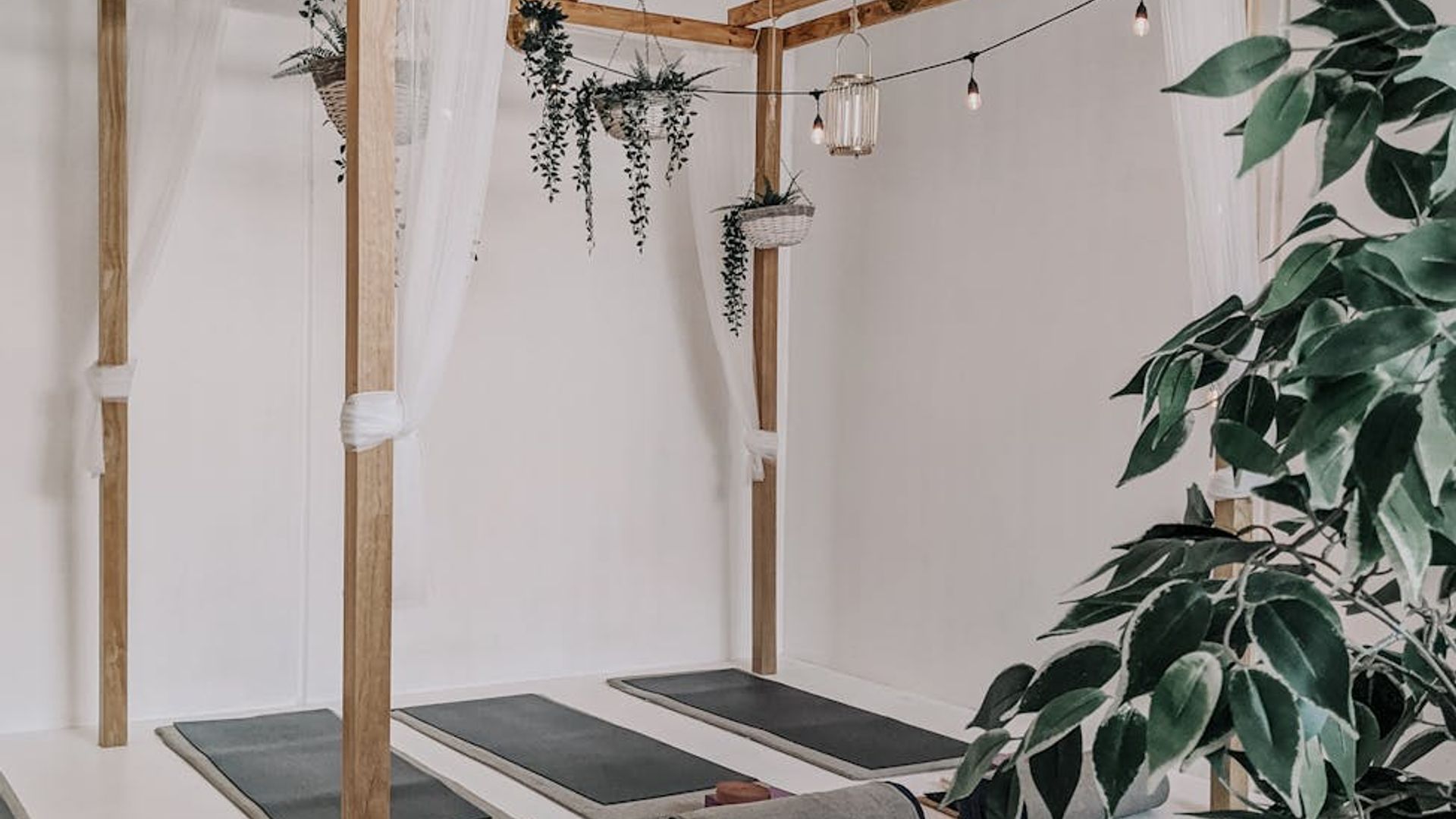 Serene yoga studio atmosphere with soft lighting and mats.